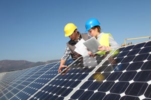 Man showing solar panels technology to student girl